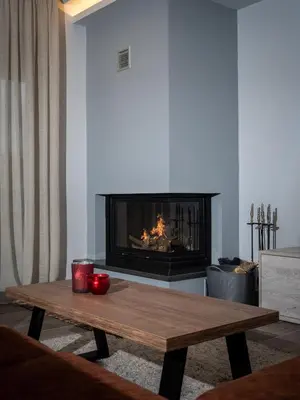 a living room with a table and a fireplace at Apartment Lazarous 3 in Apolakkiá