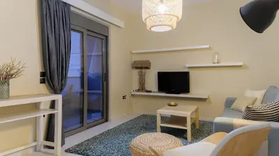 a living room with a couch and a tv at Apartment Lazarous 2 in Apolakkiá