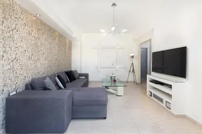 a living room with a couch and a tv at Alina in Triánta