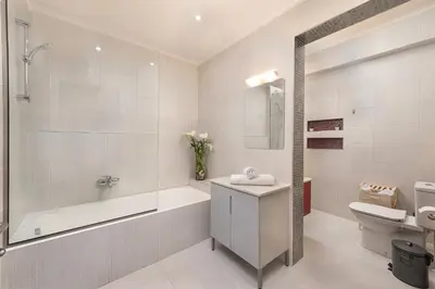 a bathroom with a tub and a toilet and a sink at Alina in Triánta