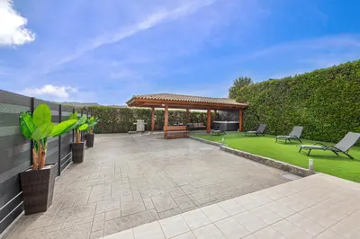 a patio with a gazebo and a lawn at Alina in Triánta