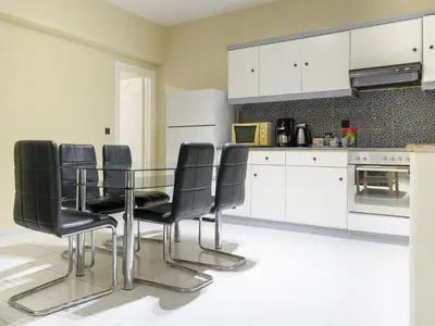 a kitchen with a glass table and black chairs at Apartment Lazarous 1 in Apolakkiá