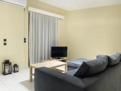 a living room with a couch and a television at Apartment Lazarous 1 in Apolakkiá