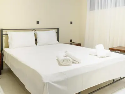 a large white bed with white towels on it at Apartment Lazarous 1 in Apolakkiá