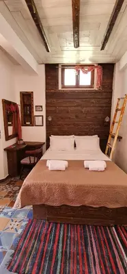 a bedroom with a large bed with two towels on it at Ey Sofias Suites in Rhodes Town