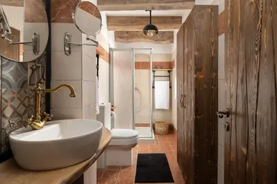 a bathroom with a sink and a toilet at Ey Sofias Suites in Rhodes Town
