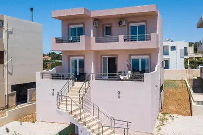 a house with stairs in front of it at Kalypso Sea View Villa in Koskinou