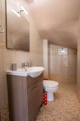 a bathroom with a sink and a toilet at Kalypso Sea View Villa in Koskinou