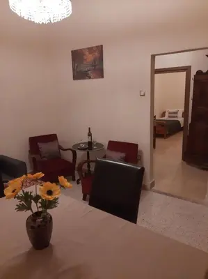 a dining room with a table and chairs and a room with a mirror at DIMITRA HOUSE in Rhodes Town