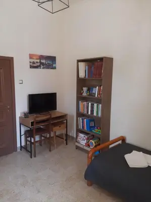 a bedroom with a desk with a computer and a book shelf at DIMITRA HOUSE in Rhodes Town