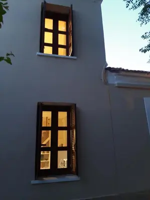 two windows in a building with the lights on at DIMITRA HOUSE in Rhodes Town