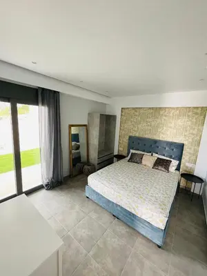 a bedroom with a bed and a large window at Vixen Apartment in Theologos