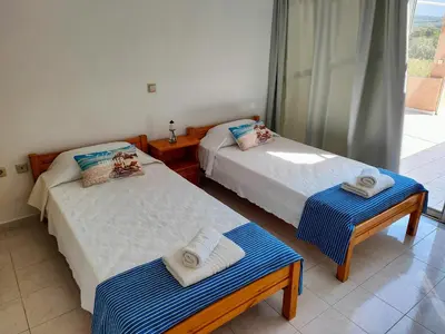 a room with two beds with towels on them at East View Appartment (Thanasis 1) in Kalavárda