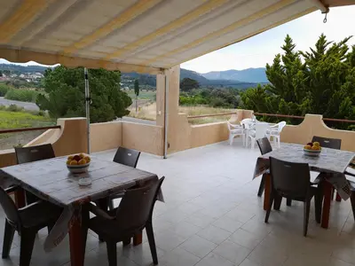 a patio with two tables and chairs and a view at East View Appartment (Thanasis 1) in Kalavárda