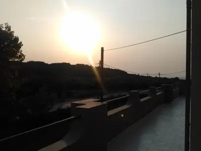 a sunset on a bridge over a river at East View Appartment (Thanasis 1) in Kalavárda