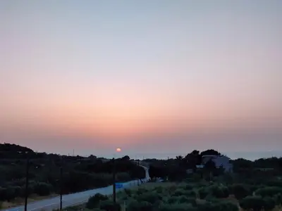 a sunset over a road in the desert at Sunset View Appartment (Thanasis 3) in Kalavárda