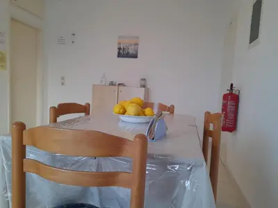 a dining room table with a bowl of fruit on it at Sunset View Appartment (Thanasis 3) in Kalavárda