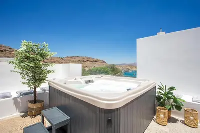 a hot tub on the balcony of a building at Villa Euphrosyne in Líndos