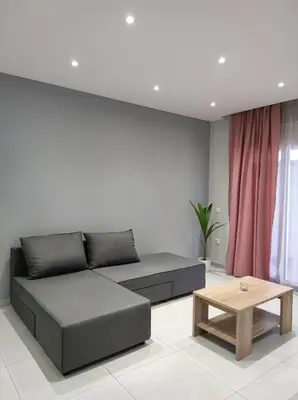 a living room with a couch and a coffee table at Nostalgia Apartment in Archangelos