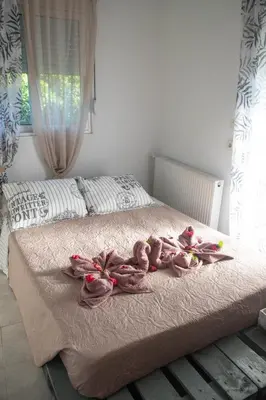 a group of pink ducks sitting on a bed at Livadi house in Theologos
