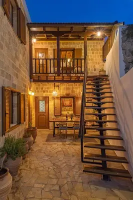 a house with a staircase leading to a patio at Margaritis Luxury Medieval House in Rhodes Town