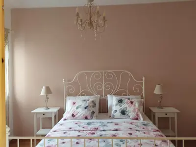 a bedroom with a bed and two tables with lamps at Olivelia in Ixia