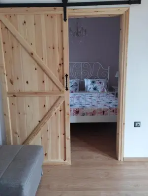 a door leading into a bedroom with a bed at Olivelia in Ixia
