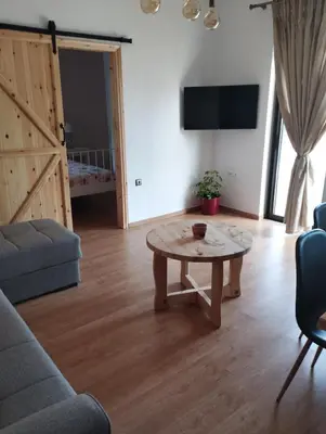 a living room with a table and a couch at Olivelia in Ixia