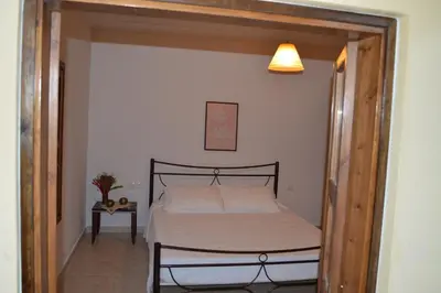 a bedroom with a bed with a wooden frame at Summer Knights in Rhodes Town