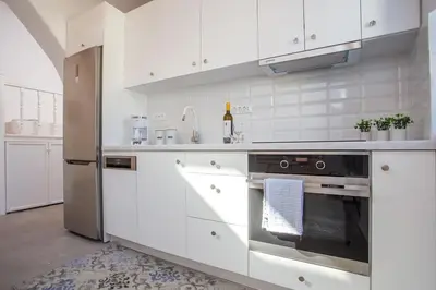 a kitchen with white cabinets and a stainless steel oven at Traditional Luxury House in Kalithies
