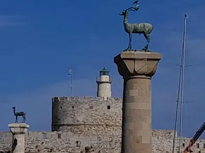 a statue of a goat on top of a building with a lighthouse at Kypseli studio rhodes in Kremasti