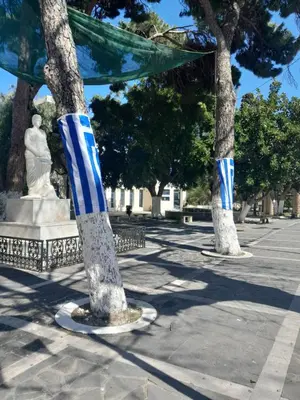 two trees with blue and white stripes on them at Kypseli studio rhodes in Kremasti