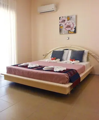 a bedroom with a large bed with towels on it at Luxury Rhodian Panorama in Ixia