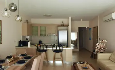 a kitchen and living room with a table and chairs at Luxury Rhodian Panorama in Ixia