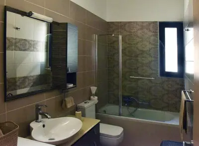 a bathroom with a sink and a toilet and a shower at Luxury Rhodian Panorama in Ixia