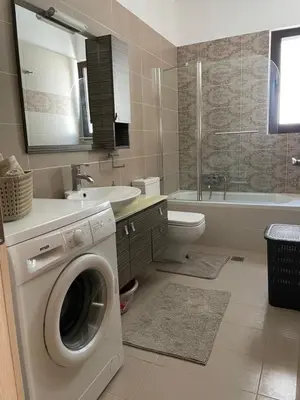 a bathroom with a washing machine and a sink at Luxury Rhodian Panorama in Ixia