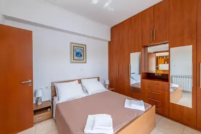 a small bedroom with a bed and a mirror at Villa Di Georgia in Afantou