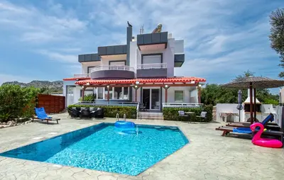 a villa with a swimming pool and a house at Villa Di Georgia in Afantou