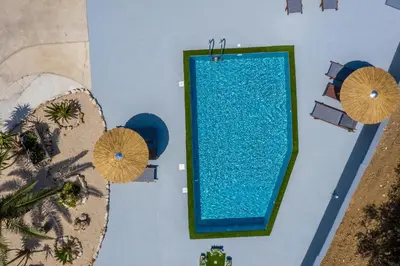 an overhead view of a swimming pool with umbrellas at Villa Di Georgia in Afantou