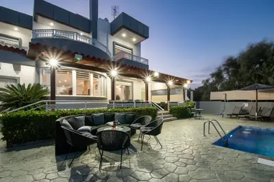 a house with a patio and a swimming pool at Villa Di Georgia in Afantou