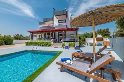 a villa with a swimming pool and a house at Villa Di Georgia in Afantou