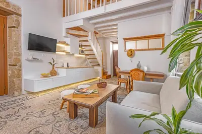 a living room with a couch and a table at Sala Historical Luxury Suites in Rhodes Town