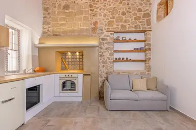 a living room with a couch in a kitchen at Sala Historical Luxury Suites in Rhodes Town