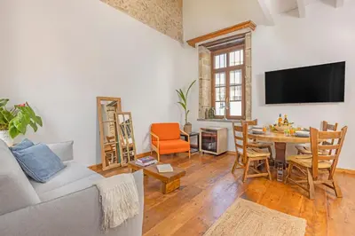 a living room with a couch and a table at Sala Historical Luxury Suites in Rhodes Town