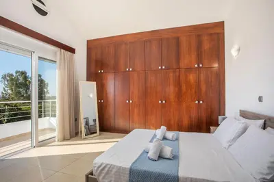 a bedroom with a bed with two stuffed animals on it at Summer Dream Villa in Afantou