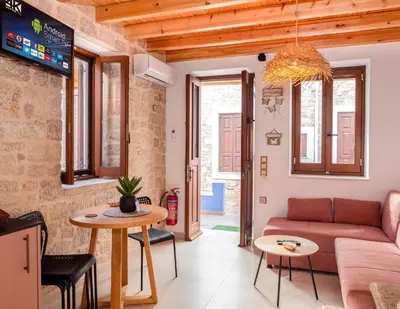 a living room with a couch and a table at Captain's Memories Stylish Harbour Apartments in Halki
