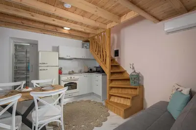 a small kitchen with a staircase in a room at Captain's Memories Stylish Harbour Apartments in Halki