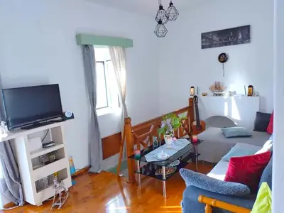 a living room with a couch and a tv at Ornella's & Laura's secret place in Livadia