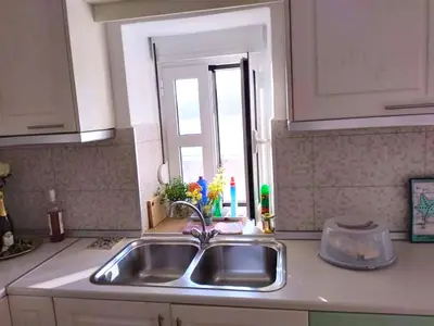 a kitchen counter with a sink and a window at Ornella's & Laura's secret place in Livadia
