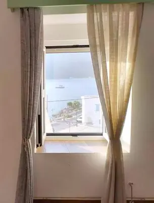 a window in a room with a view of the ocean at Ornella's & Laura's secret place in Livadia